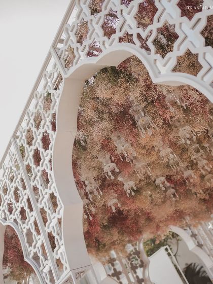 Looking up at the ceiling of the mandap, which is covered in a dense canopy of pastel-hued baby's breath. This creates a dreamy, cloud-like effect above the ceremony.