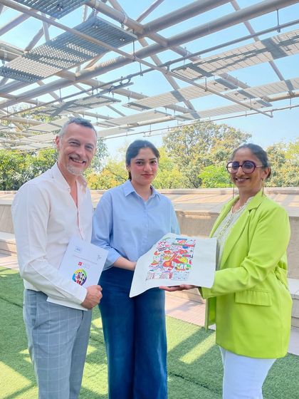 Our directors present the winning tote bag design to the student artist. We take pride in recognizing and promoting the creativity within our community.