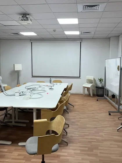 The conference room within the IKEA facility, featuring a large meeting table, projector setup, and functional seating. This space was designed and executed by our team to support collaborative meetings and presentations.