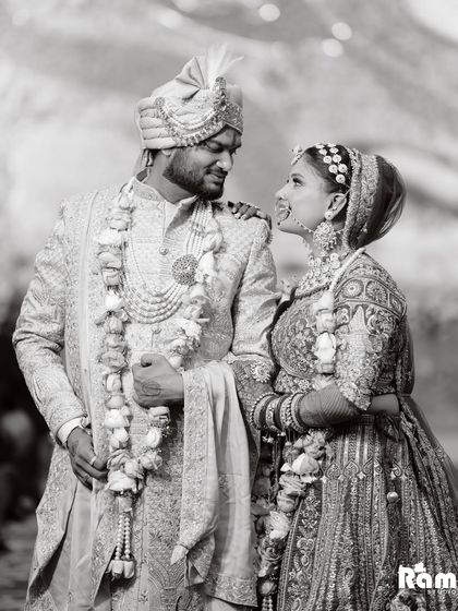 A beautiful black and white portrait of the couple sharing a candid moment. The bride's hand on the groom's shoulder and their loving expressions make this a heartwarming shot.