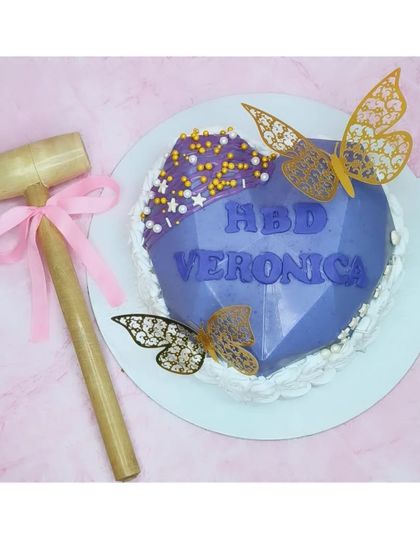 A smashable pinata cake with a surprise inside. This one is a chocolate truffle flavor, hidden inside a breakable chocolate heart that you can smash with a hammer.