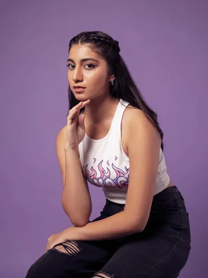 A seated portrait that feels thoughtful and relaxed. The purple background keeps it modern and fresh.