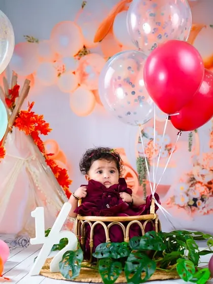 Halfway to one. This setup with colorful balloons and a teepee is a fun way to celebrate the six-month milestone.
