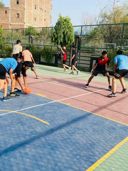 Players practice defensive slides, a key drill for improving lateral quickness and on-ball defense.