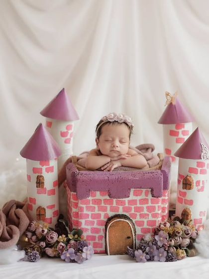 A wider view of the princess castle setup, complete with fluffy clouds and a dreamy, soft background.