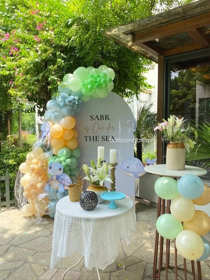 A wider view of the 'Under the Sea' party, showing the cake table and additional balloon arrangements.