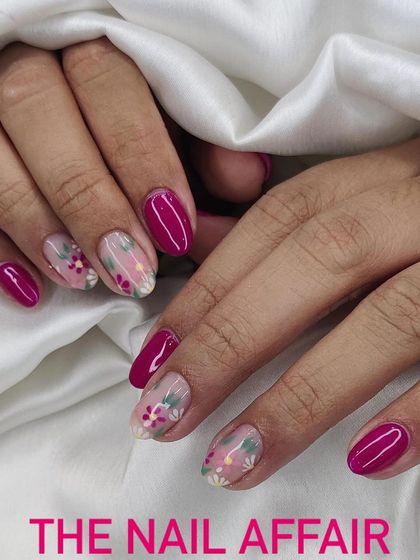 A beautiful floral design on a negative space background, paired with solid magenta nails. The mix of detailed art and bold color creates a balanced and stylish look.
