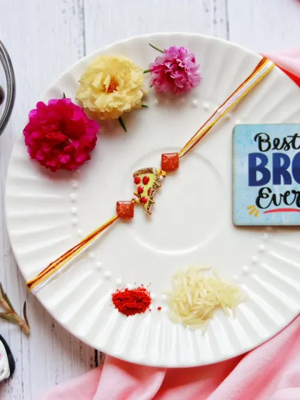 A celebration of the beautiful bond between siblings. I prepared this Rakhi thali with a vibrant rakhi, fresh flowers, and traditional elements, adding a fun pizza charm for the "Best Bro Ever."