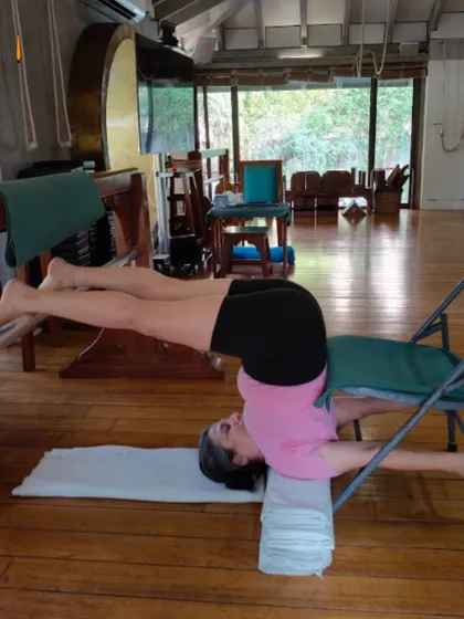 In Iyengar yoga, props like chairs and blankets are not for comfort; they are scientific tools for alignment. This supported shoulder stand (Sarvangasana) variation allows the body to achieve the correct posture safely, calming the nervous system and improving circulation without straining the neck. This is how we make the practice accessible and therapeutic for every body type.