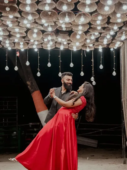 A romantic dance under a canopy of lights. This pre-wedding night shoot captures a magical, movie-like moment.