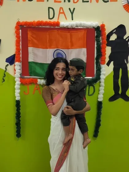 A proud moment during our Independence Day celebration, holding a student dressed as a soldier. We instill a sense of patriotism and respect for our country from a young age.