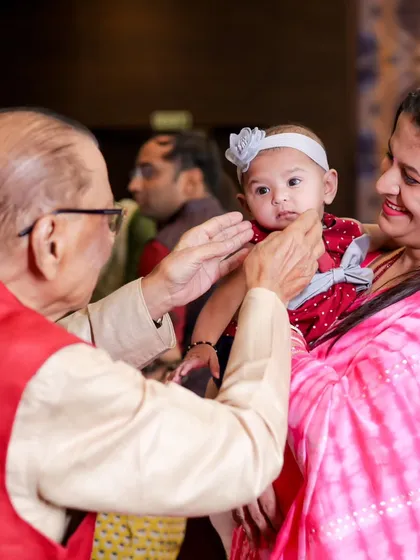 A tender moment between a grandfather and a baby. These multi-generational photos are precious memories from a family wedding.