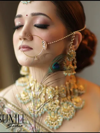 An artistic bridal shot featuring a peacock feather. This shows how to incorporate creative elements into a portfolio to make it stand out.