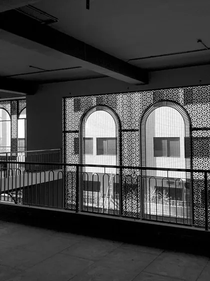 Brewing architecture with as much craft as the perfect pint. This black and white shot shows the interior of a brewery in progress, with arched windows and intricate screens.