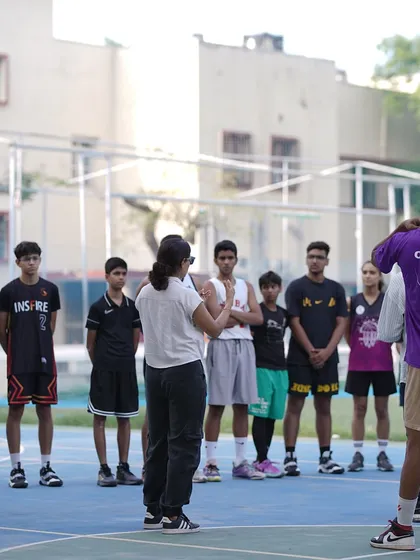 Coaches and mentors address the group of young athletes, sharing their knowledge and passion for the game.