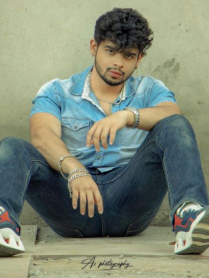 A low-angle shot of a model in a denim-on-denim outfit. This perspective adds a dynamic and powerful feel to a classic casual look.