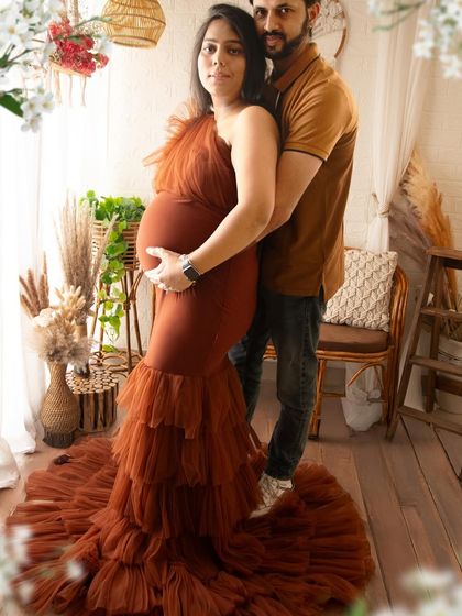 A beautiful couple pose in our warm, rustic boho setting. The earthy tones of the gown and decor create a cohesive and natural look for this lifestyle maternity portrait.