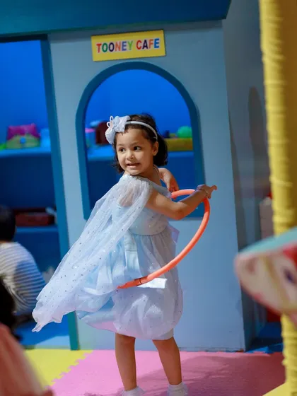 Hula hooping fun right outside the Tooney Cafe. Our space encourages kids to mix active play with imaginative scenarios.