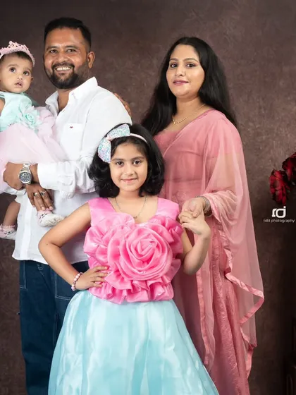 A beautiful family portrait is a treasure that lasts forever. Here, we have three generations of love in one frame, with everyone coordinated in a classic studio setting. It’s a perfect example of a timeless family photo.