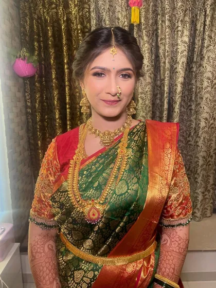 Capturing the beauty of tradition with a stunning Puja look before the engagement ceremony. The makeup is classic, with gold tones to match her beautiful saree.