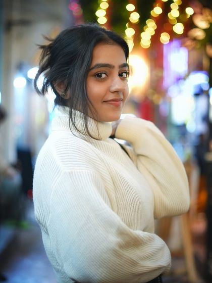 A slightly different angle of the previous pose, this shot captures another beautiful expression. The soft lighting is very flattering and adds to the cozy winter vibe.