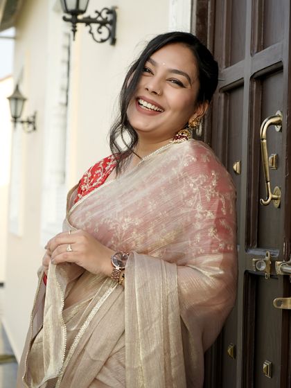 A client looking lovely in an organza saree, paired with my classic red and gold jhumkas.
