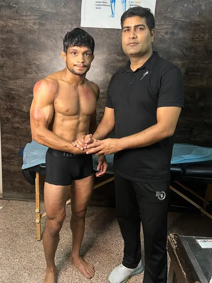 Shaking hands with wrestler Amit Kumar after his session.