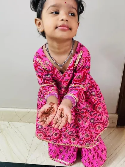 My adorable little client showing off her Diwali mehendi. It's moments like these that make my work so rewarding!
