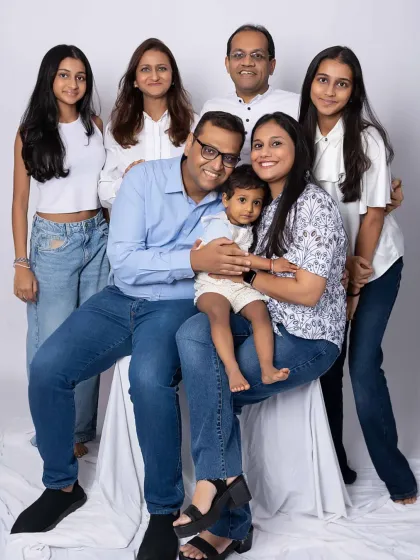 A lovely family group portrait, perfectly posed to show connection and individual personalities. The classic white and blue color scheme creates a fresh and timeless look.
