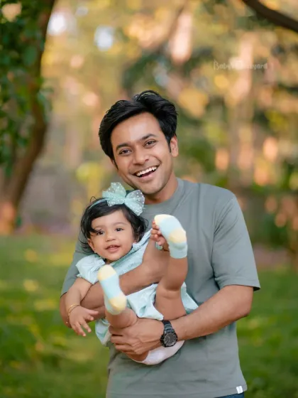 Daddy’s little bundle of joy! This father's bright smile shows the pure happiness he feels while holding his daughter during their outdoor family session.