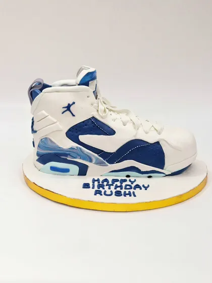A side view of the sculpted Nike sneaker cake, capturing the classic shoe silhouette perfectly.