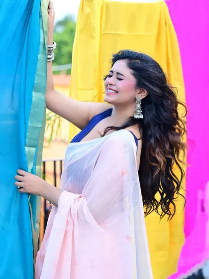 A candid, smiling shot from the same colorful series. This image captures a moment of pure joy, with the bright background enhancing the cheerful mood of the photograph.