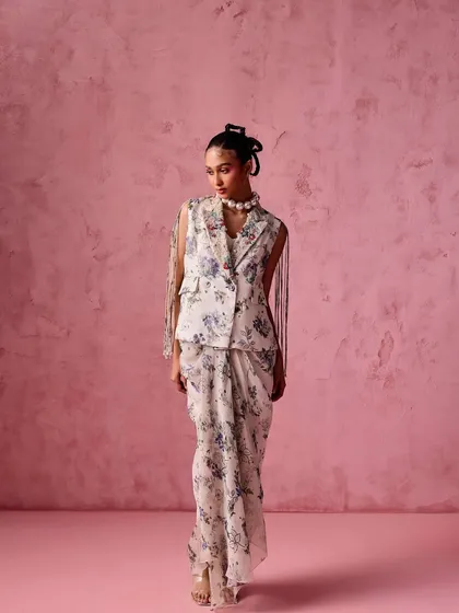 A full view of the floral draped skirt and sleeveless blazer, showcasing a unique and fashion-forward approach to festive dressing.