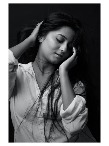 A classic portrait where the wind adds a touch of life. The black and white conversion brings out the texture of her hair and the honesty in her expression, resulting in a simple yet captivating headshot.