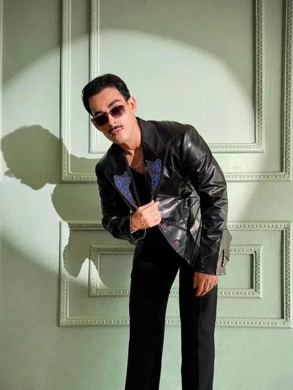 Giri Sawalkar takes center stage in the Enigma Set, a black leather suit with multi-structured patterns. The metal-studded collar and leather belt elevate this look for those who embrace bold fashion.