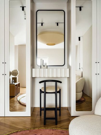 We plan for premium and usable interiors. This unique dresser unit is built between two wardrobes, featuring a fluted panel design and a backlit mirror, making excellent use of a narrow space.