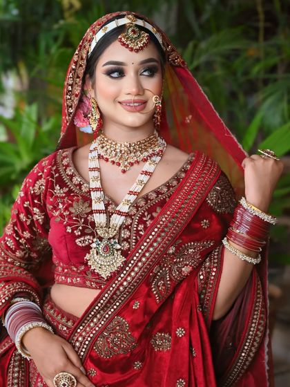A happy and confident bride, ready for her big day. The traditional jewelry and makeup come together perfectly.