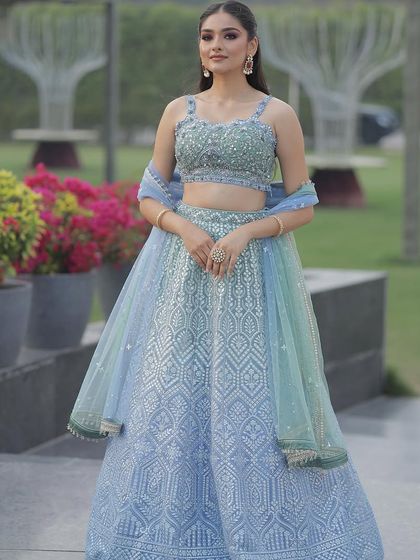 A full-length portrait in the ice blue lehenga. The subtle sparkle and fresh colors make it an elegant and sophisticated choice for a modern bridesmaid.