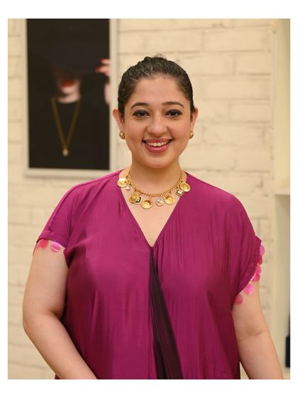 A happy client posing with her new find, a beautiful coin necklace. My goal is to help you find pieces that bring a smile to your face every time you wear them.