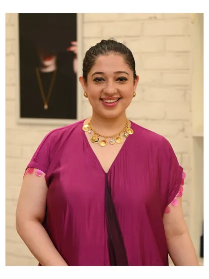 A happy client posing with her new find, a beautiful coin necklace. My goal is to help you find pieces that bring a smile to your face every time you wear them.
