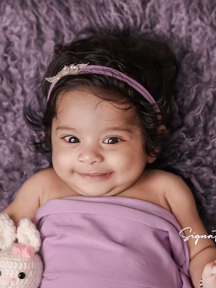 A duplicate of image 134, a happy and smiling four-month-old.