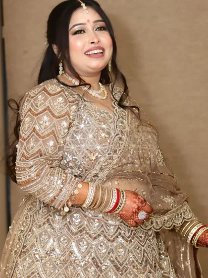 Her smile says it all. This happy bride-to-be is glowing in her golden engagement attire.