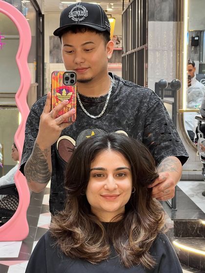 Another happy client after a fresh haircut. The soft layers and face-framing pieces give her a beautiful, refreshed look.