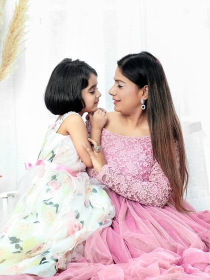 A mother's love is a fairy tale come true. This beautiful portrait captures the tender bond between a mother and her little princess.