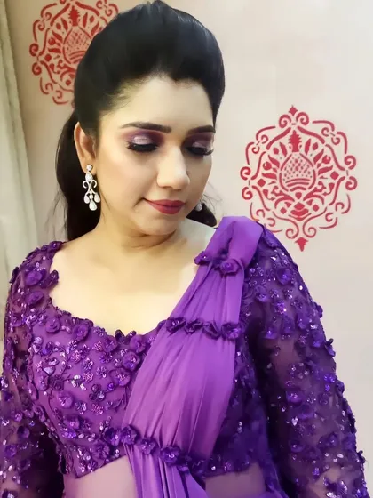This client looks stunning in her purple gown. I complemented the outfit with a soft purple smokey eye, a subtle lip, and a sleek high ponytail for a modern and chic party look.