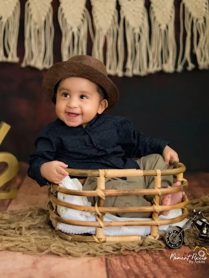 Six months old and ready to take on the world. This little traveler's happy smile is the highlight of his rustic-themed milestone session.