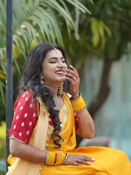 A moment of pure laughter during the Haldi ceremony. The makeup is waterproof to withstand all the fun.