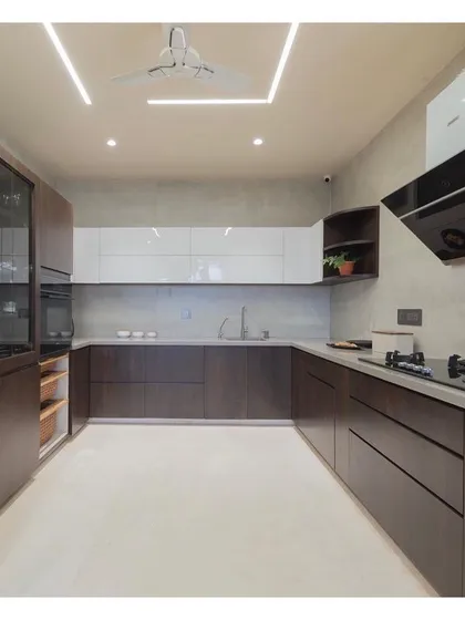 This spacious, dual-tone kitchen was designed for functionality and style. By combining dark wood grain with clean white cabinets and a clutter-free layout, I created a modern modular kitchen that is both a practical workspace and the heart of the home.