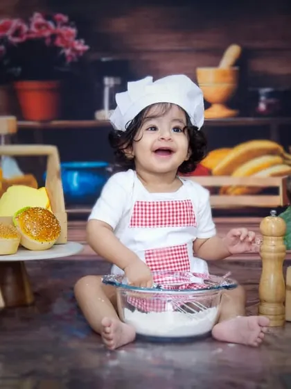 Let's get cooking. This little chef had a wonderful time playing with flour and kitchen props during his first birthday shoot, resulting in some delightfully candid and happy moments.