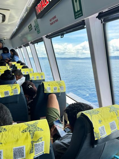 A view from the window of the high-speed ferry, cruising over the blue waters of the Andaman Sea.
